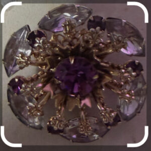 Vintage gold tone flower brooch with purple and clear rhinestones. Circa 1940's-1950's