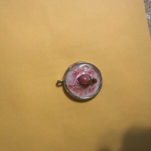 Rose Bud over white background in gold bezel